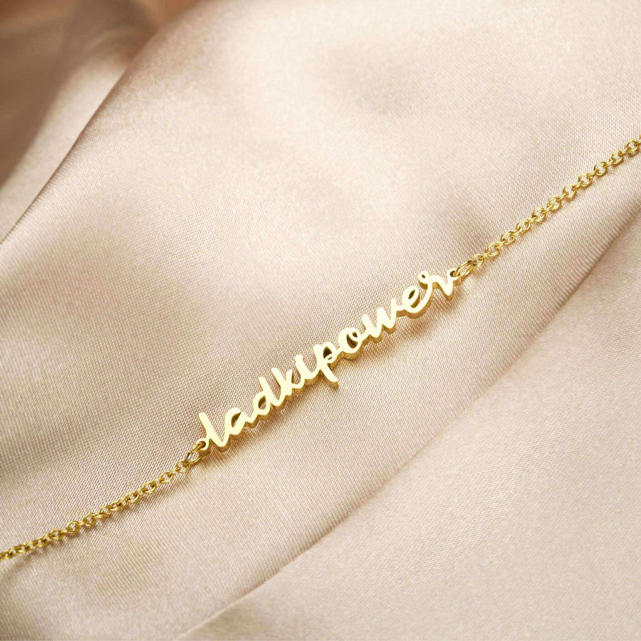 ZUDO-LadkiPower-Necklace-bgm-Gold-flatlay-fabric-side-angle_